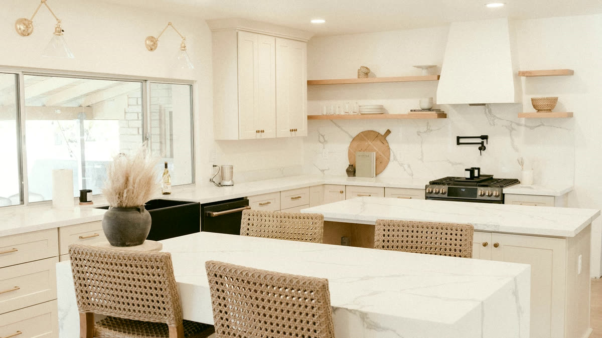 A finished galley kitchen in daylight, white oak cabinetry and a honed marble island