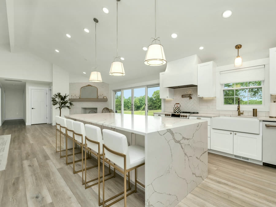 Book-Matched Island, a wide marble island under pendant light